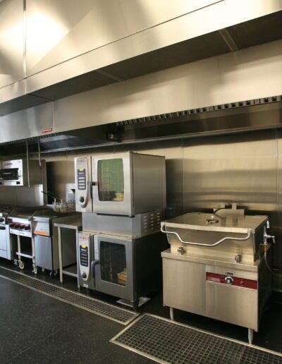 Professional kitchen with stainless steel equipment and appliances.