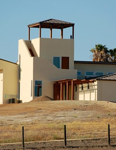 Modern house on a hill with a clear sky.