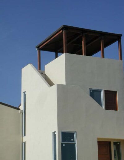 Modern building with a rooftop terrace and asymmetrical design features.