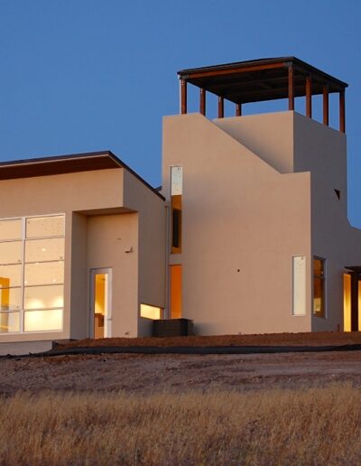 Modern house with illuminated windows at twilight.