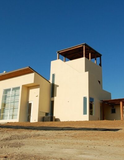Modern house under construction on a clear day with blue sky.